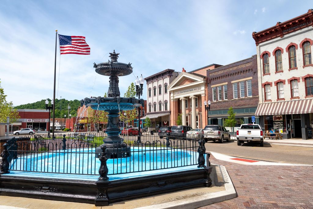 Fountain and American flag at the center of small Ohio downtown's courtyard