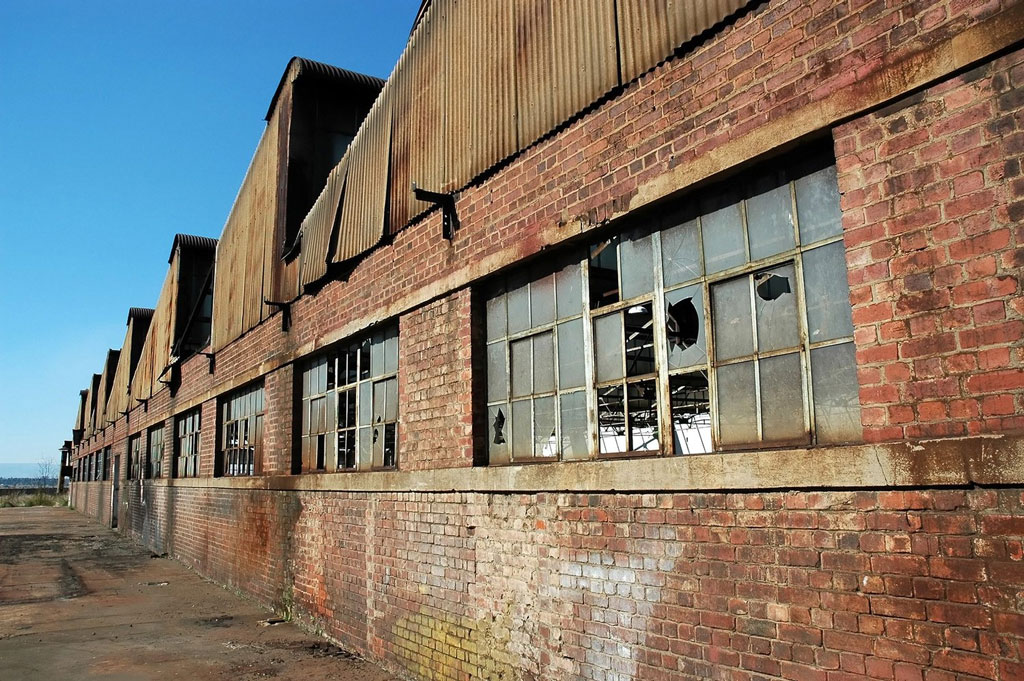 Brownfield site, warehouse with broken windows and brick walls