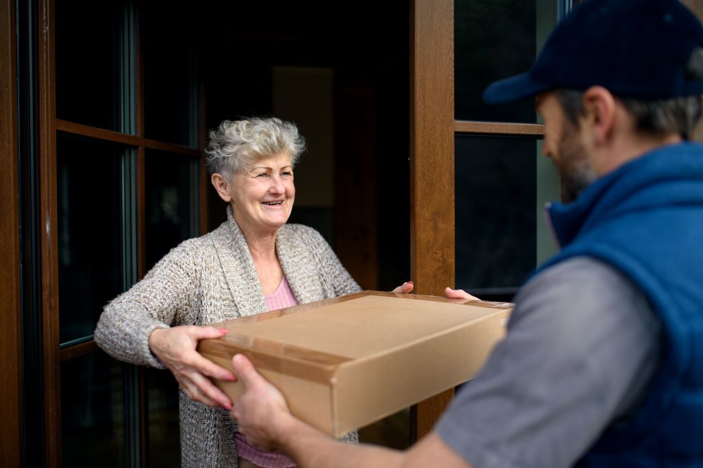 Older woman receiving a package at home