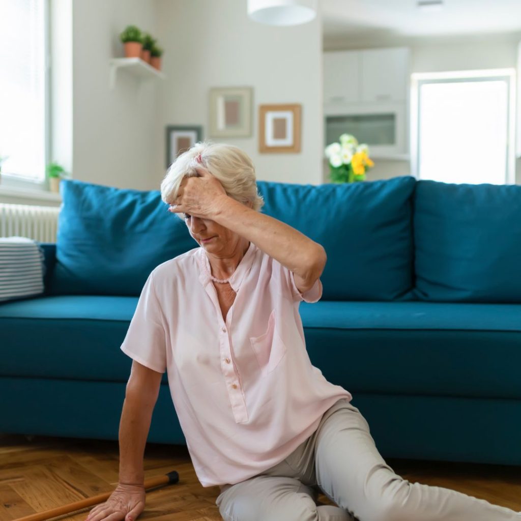 An elderly woman in distress lying on the floor