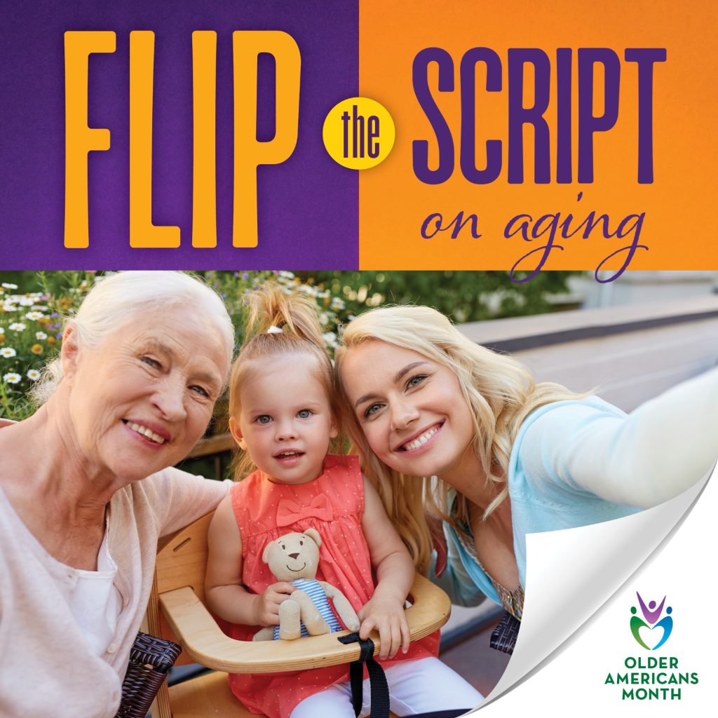 Three generations of women—an older adult, a young child, and an adult woman—smile together for a selfie in a garden setting. The top half of the image features the text "Flip the Script on Aging" in bold purple and orange colors. A curled page corner reveals the Older Americans Month logo in the bottom right corner.