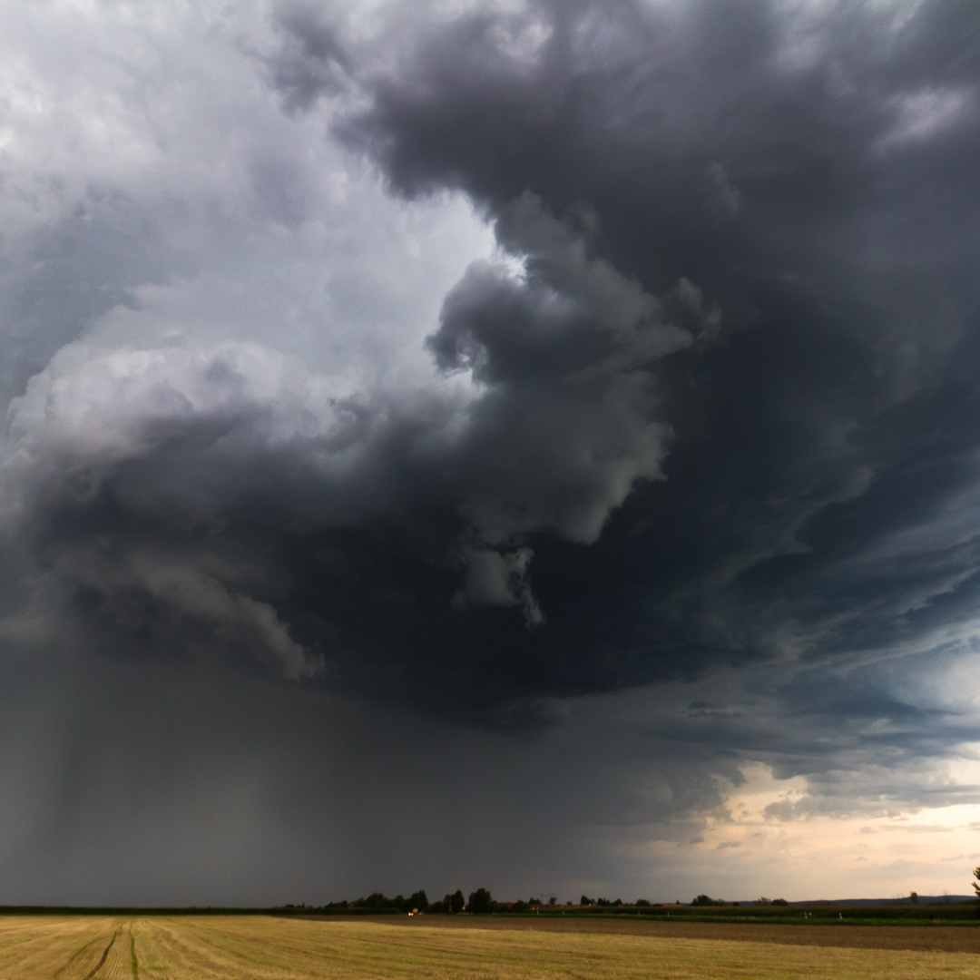 Dark storm clouds over an open field