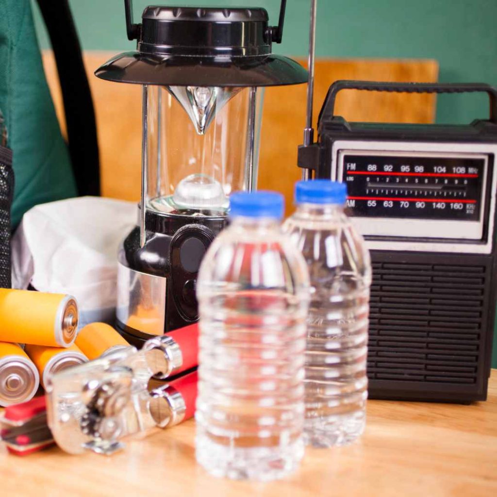 Emergency preparedness kit with water, lantern, batteries, and radio