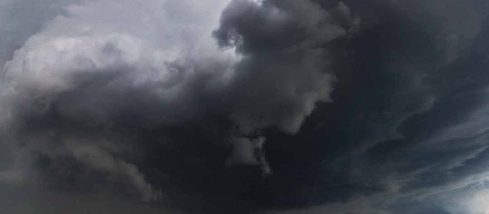 Dark storm clouds over an open field