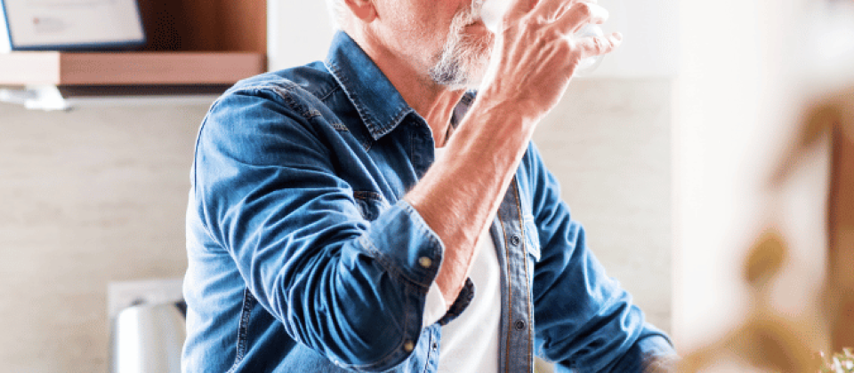 Senior male drinking from a glass