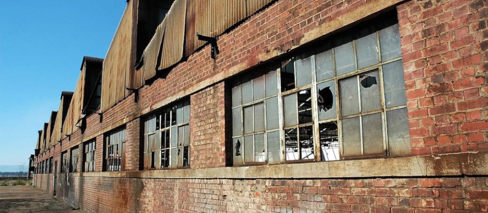 Brownfield site, warehouse with broken windows and brick walls