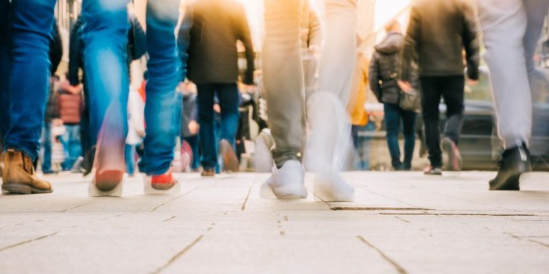 Blurred feet of people walking on busy Ohio sidewalk